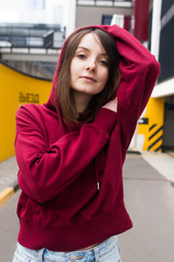 big eyes, sweet girl in burgundy hoodie, smiling and looking at you