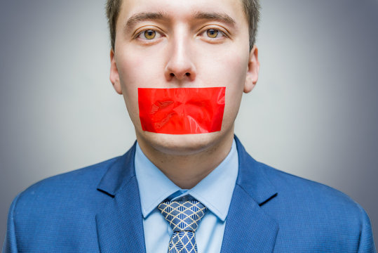 Censorship Concept. Man Is Silenced With Red Adhesive Tape On His Mouth