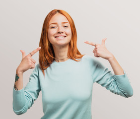 portrait of a pretty redhead girl proud of herself