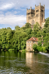 Fototapeta na wymiar cathedral towers protruding above the forest next to the river Wear near Durham. 