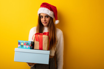 Young woman wearing santa hat celebrating christmas day