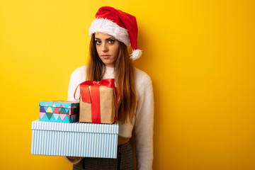 Young woman wearing santa hat celebrating christmas day