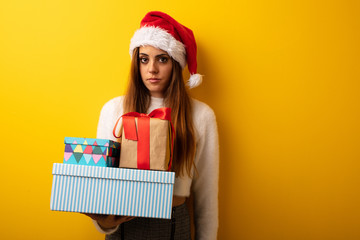 Young woman wearing santa hat celebrating christmas day