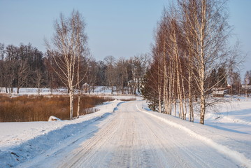 Winter snowy country road in the village