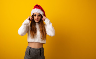 Young pretty woman holding gift doing a concentration gesture