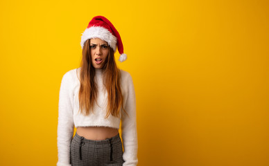 Young pretty woman holding gift screaming very angry and aggressive