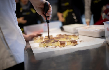 Close up of hand cutting cake