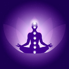 Silhouette of Person in yoga lotus asana on dark blue purple background with lotus flower and light - 247431531