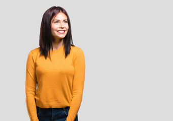 Obraz premium Young pretty woman looking up, thinking of something fun and having an idea, concept of imagination, happy and excited