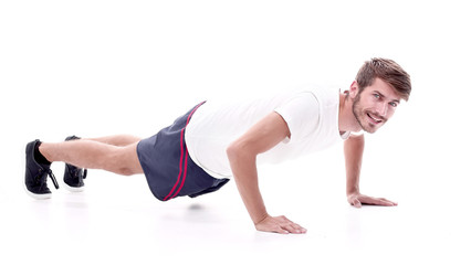 in full growth. a man performs a push-up from the floor