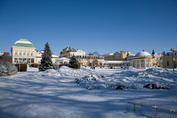 Sunny day in the center of small spa town Frantiskovy Lazne (Franzensbad) in winter under snow - west part of Czech Republic (region Karlovy Vary)