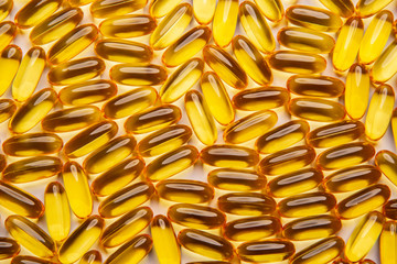 Omega-3 fish fat oil capsules on a white background.