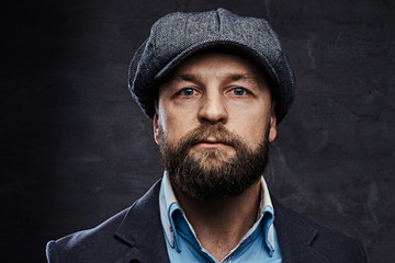 Close-up portrait of a stylish old-fashioned man wearing a beret and jacket