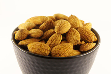 Almonds in black bowl.
