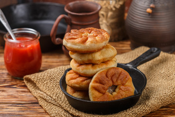 Traditional Russian (Tatar, Bashkir) fried patties with meat and onions (belyash).  Delicious pies. Selective focus, rustic style