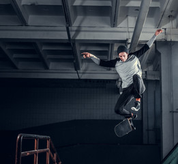 Skateboarder jumping high on mini ramp at skate park indoor. © Fxquadro