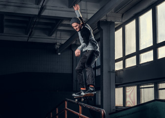 Skateboarder performing a trick on mini ramp at skate park indoor.