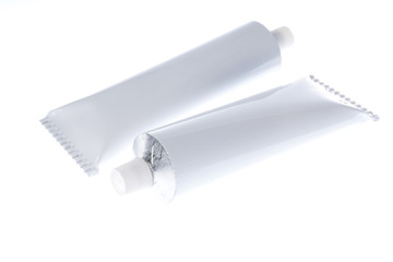 Close up of aluminum tube isolated on white background. Cosmetic or medicine gel.