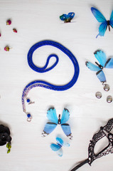 Beaded tie necklace. Blue jewelry on the white wooden background. Women accessories