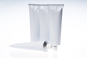 Close up of aluminum tube isolated on white background. Cosmetic or medicine gel.