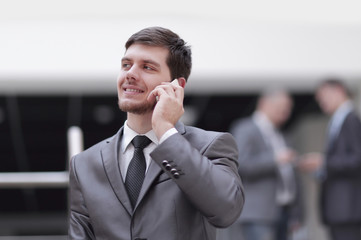 portrait of handsome businessman on blurred office background