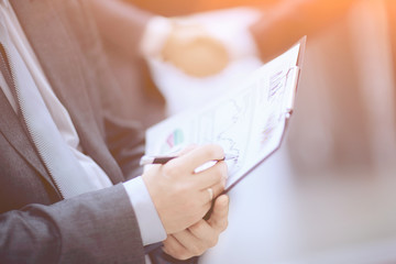 close up. businessman with financial graph on background of bus