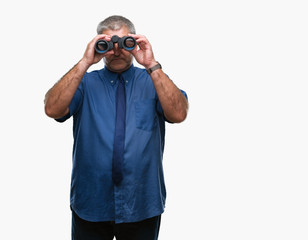 Handsome senior man looking through binoculars over isolated background with a confident expression on smart face thinking serious