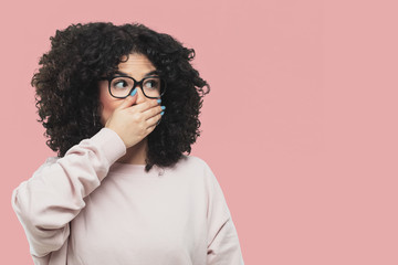 young woman covering her mouth