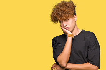 Obraz na płótnie Canvas Young handsome man with afro hair wearing black t-shirt thinking looking tired and bored with depression problems with crossed arms.
