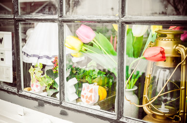Decorative flowers in vase on window