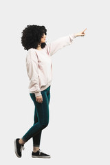 Full body young woman pointing aside