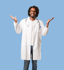 Handsome african american medical doctor laughing and having fun, being relaxed and cheerful, feels confident and successful