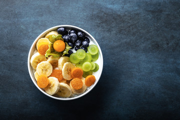 yogurt with fruits, grapes, physalis, bananas and blueberries