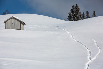 Fototapeta na wymiar Deeply snow-covered landscape in Switzerland