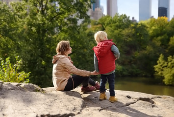 Woman and her charming little son admire the views in Central Park, new York