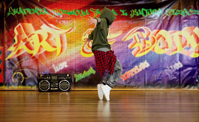 hip hop dancer on the background of graffiti and boombox, unique situation, girl 