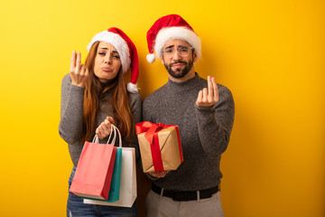 Couple or friends holding gifts and shopping bags doing a gesture of need