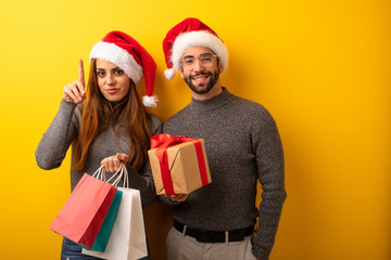 Couple or friends holding gifts and shopping bags showing number one