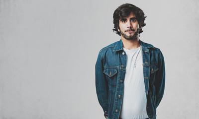 Young handsome man doubting and confused, thinking of an idea or worried about something