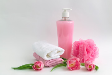 Fototapeta na wymiar Liquid soap and two towels on a white background.