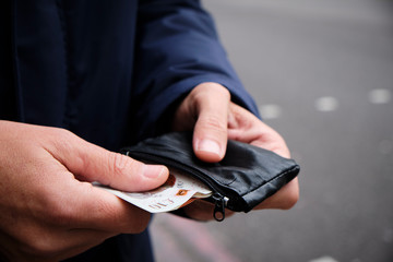 man putting in or taking off money from his wallet