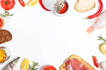 Healthy food clean eating selection: fruit, vegetable, seeds, fish, meat, leaf vegetable on white background. Top view.