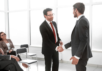 businessmen handshaking after striking grand deal