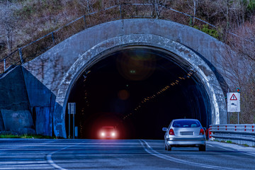 cars drive through a mountain road tunnel on the evening in Atina in the Italian Lazio region