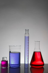 Liquid in laboratory bottles. Scientific biochemical laboratory. Colorful liquid.