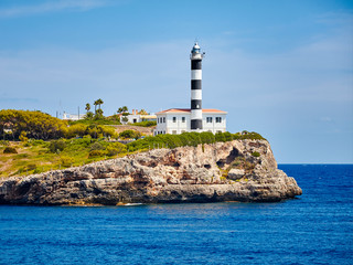 Portocolom Lighthouse on a cliff, Mallorca, Spain.