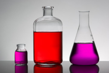 Liquid in laboratory bottles. Scientific biochemical laboratory. Colorful liquid.