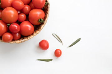 fresh tomatoes in a basket on a white background