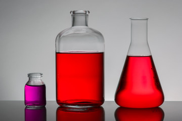 Liquid in laboratory bottles. Scientific biochemical laboratory. Colorful liquid.