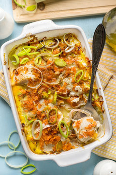 Oven dish gratin with cod fish, carrots and leeks